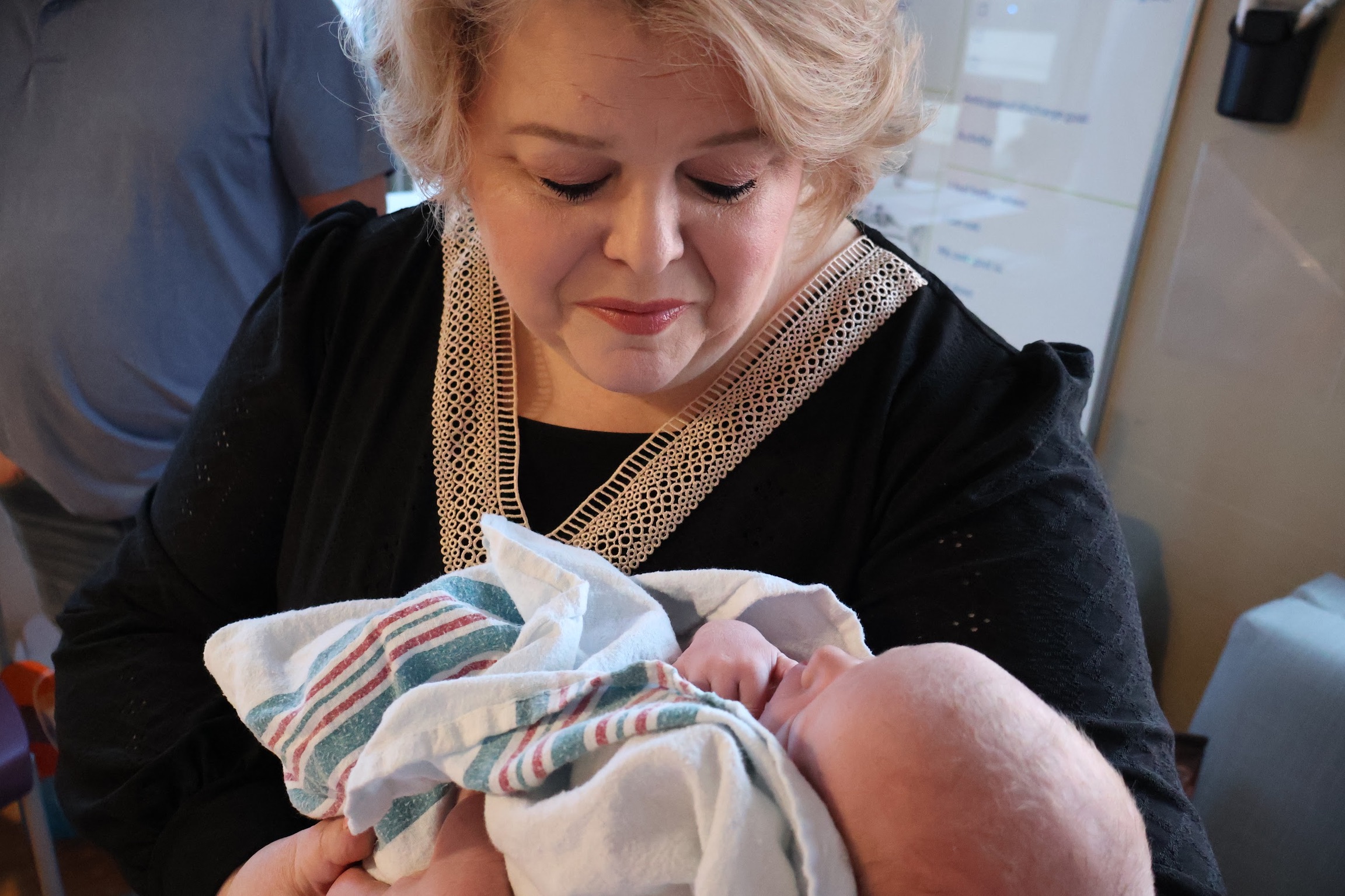 Holding a newborn in a family photograph
